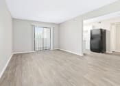 Thumbnail 2 of 16 - a bedroom with a large window and hardwood flooring