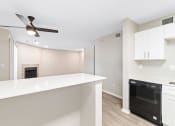 Thumbnail 4 of 16 - a kitchen with a white counter top and a black dishwasher