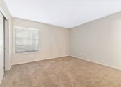 Thumbnail 7 of 16 - a bedroom with beige carpet and a window