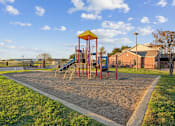 Thumbnail 12 of 16 - A playground with a yellow and red slide and a yellow and red structure.