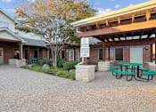 Thumbnail 13 of 16 - A building with a picnic table in front of it.