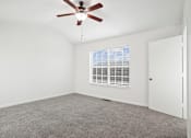 Thumbnail 2 of 16 - A room with a ceiling fan and a window with blinds.
