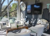 Thumbnail 6 of 17 - a living room with white furniture and a television