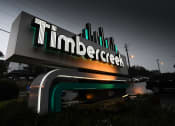 Thumbnail 17 of 17 - a sign for the tilden corporation in front of a parking lot at night