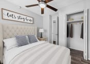 Thumbnail 3 of 17 - a bedroom with a large bed and a ceiling fan