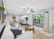 Thumbnail 1 of 17 - a living room with a white couch and a ceiling fan