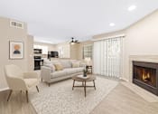 Thumbnail 1 of 23 - A living room with a fireplace and a ceiling fan.