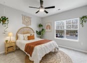 Thumbnail 42 of 45 - A bedroom with a bed, a ceiling fan, and a window.