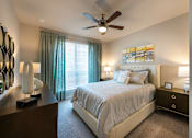 Thumbnail 7 of 25 - a bedroom with a bed and a ceiling fan