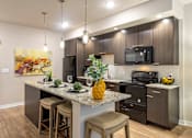 Thumbnail 1 of 25 - a kitchen with a large island with stools