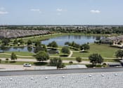 Thumbnail 25 of 25 - an aerial view of a pond in a neighborhood with houses