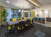 Thumbnail 14 of 25 - a conference room with a table and chairs and a kitchen