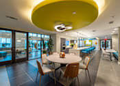 Thumbnail 17 of 25 - a dining room with a table and chairs and a large yellow ceiling