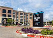 Thumbnail 22 of 25 - a large building with a sign for town center lofts