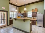 Thumbnail 26 of 35 - a kitchen with a large island and a refrigerator