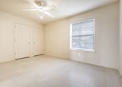 Thumbnail 5 of 23 - Empty room with a ceiling fan and a window.