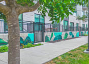 Thumbnail 11 of 41 - a sidewalk with a mural on the side of a building