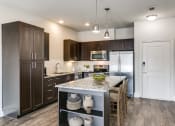 Thumbnail 7 of 42 - a kitchen with stainless steel appliances and a marble counter top