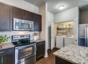 Thumbnail 8 of 42 - a kitchen with stainless steel appliances and granite counter tops