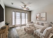 Thumbnail 10 of 42 - an open living room with a ceiling fan and a couch