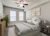 Thumbnail 11 of 42 - a bedroom with a bed and a ceiling fan