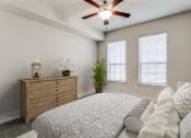 Thumbnail 12 of 42 - an empty bedroom with a bed and a ceiling fan