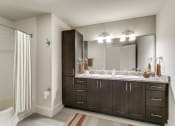 Thumbnail 41 of 42 - a bathroom with two sinks and a shower and a mirror