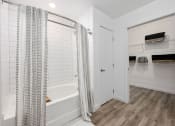 Thumbnail 15 of 66 - a bathroom with a shower and a tub and a closet