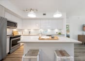 Thumbnail 2 of 66 - a kitchen with an island and a stove and a refrigerator