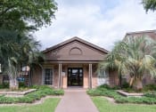 Thumbnail 37 of 37 - the front of a brick building with palm trees