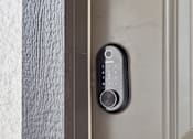 Thumbnail 27 of 41 - A modern door handle with a keypad and a round knob.