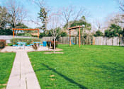 Thumbnail 28 of 28 - a backyard with a picnic area and a swing set