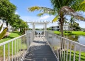 Thumbnail 22 of 41 - a white bridge over a body of water with palm trees