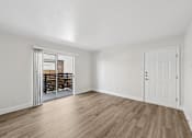 Thumbnail 23 of 38 - A room with wooden flooring and white walls.