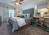 Thumbnail 8 of 28 - A bedroom with a bed, dresser, and mirror.