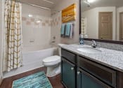 Thumbnail 7 of 28 - A bathroom with a toilet, sink, and shower.