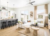 Thumbnail 2 of 18 - a living room and kitchen with white walls and wood floors