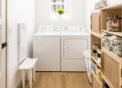 Thumbnail 6 of 18 - a small laundry room with a washer and dryer