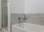 Thumbnail 11 of 33 - a bathroom with a bathtub and a shower