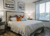 Thumbnail 9 of 33 - a bedroom with a bed and two windows