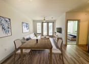 Thumbnail 22 of 33 - A dining room with a wooden table and chairs.