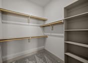 Thumbnail 7 of 36 - Empty shelves in a room with grey carpet.