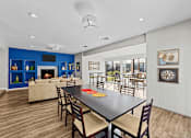 Thumbnail 15 of 17 - A modern dining room with a black table and chairs.