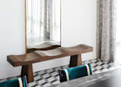 Thumbnail 18 of 22 - A mirror with a wooden frame is leaning against a wall.