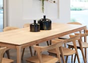 Thumbnail 15 of 22 - A dining table with chairs and a wreath on the wall.