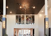 Thumbnail 16 of 22 - A reception area with a white counter and a ceiling fan.