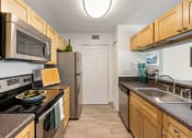 Thumbnail 38 of 41 - a kitchen with stainless steel appliances and granite counter tops and