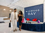 Thumbnail 2 of 76 - A man and woman are standing in front of a Wynwood Bay sign.