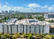 Thumbnail 61 of 66 - an aerial view of an apartment building with the city skyline in the background