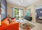 Thumbnail 36 of 44 - a living room with an orange couch and a coffee table